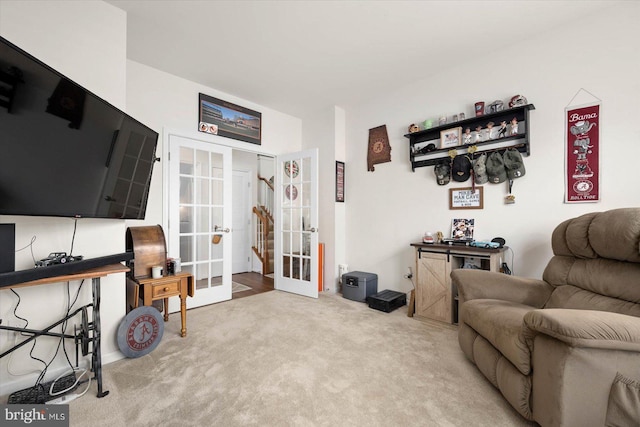 sitting room with carpet floors and french doors