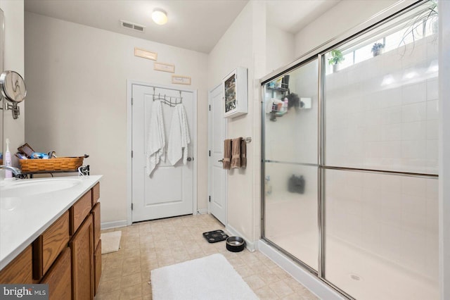 bathroom featuring an enclosed shower and vanity