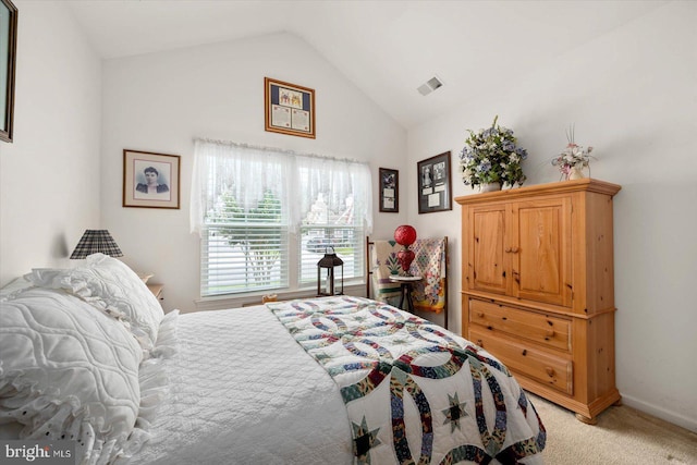 bedroom featuring lofted ceiling and light carpet