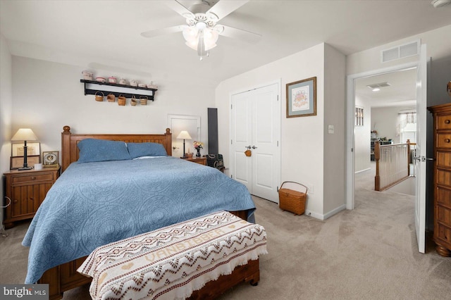 carpeted bedroom featuring ceiling fan and a closet