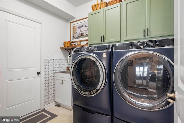 laundry room with washer and dryer and cabinets