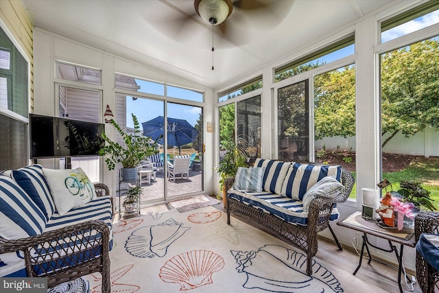 sunroom featuring vaulted ceiling, ceiling fan, and a healthy amount of sunlight