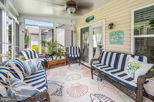 sunroom / solarium featuring ceiling fan