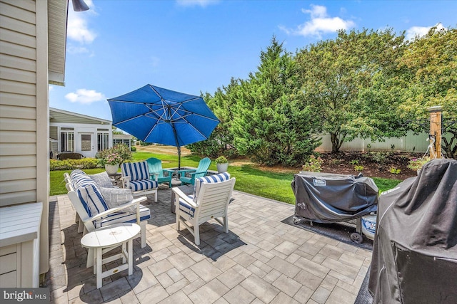 view of patio with outdoor lounge area and a grill