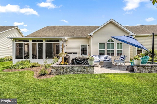 rear view of house featuring a yard, an outdoor living space, a patio, and a sunroom