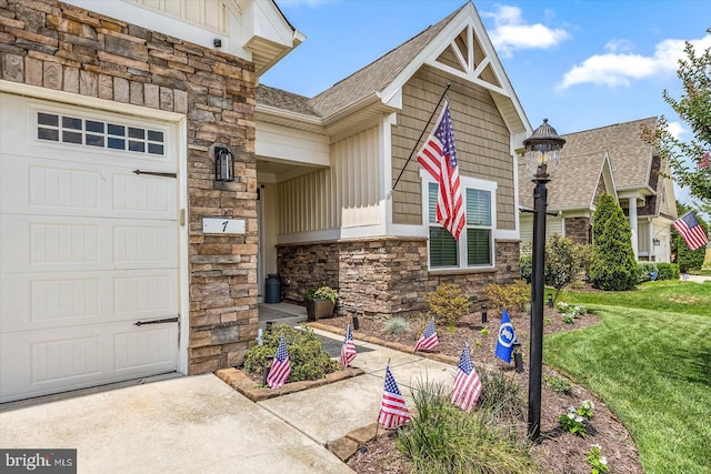 doorway to property featuring a garage and a lawn