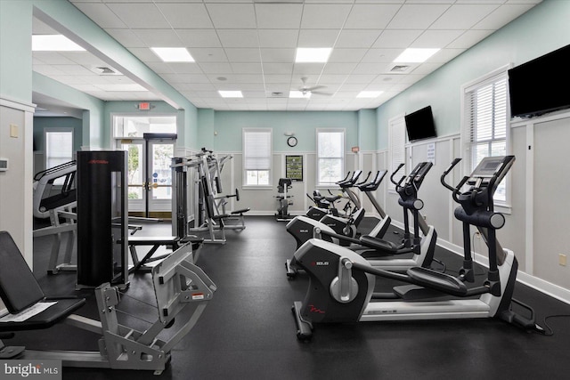 workout area with ceiling fan and a paneled ceiling