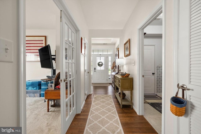 corridor with dark hardwood / wood-style floors and french doors