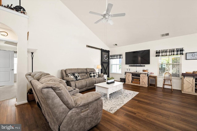 living room with ceiling fan, plenty of natural light, dark hardwood / wood-style floors, and high vaulted ceiling