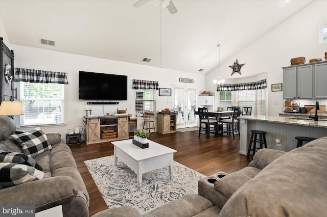 living room with ceiling fan, dark hardwood / wood-style flooring, sink, and high vaulted ceiling