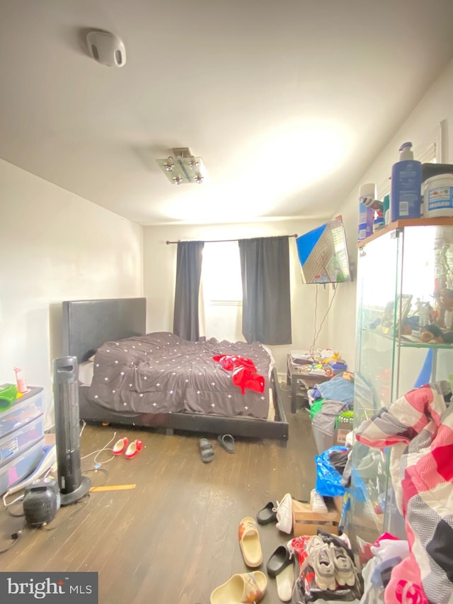 bedroom featuring multiple windows and hardwood / wood-style floors