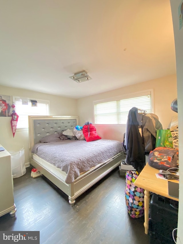 bedroom with hardwood / wood-style flooring