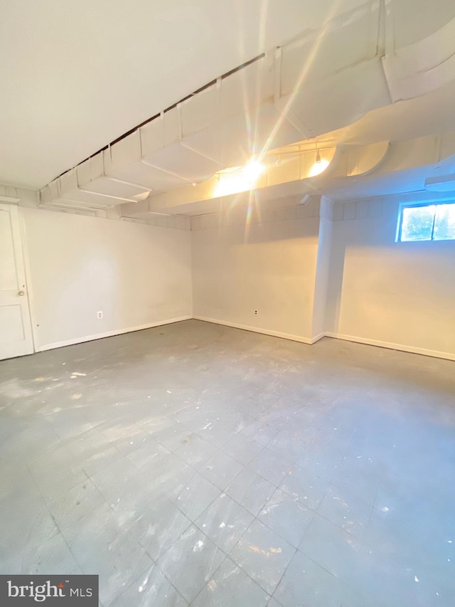 unfinished basement featuring baseboards