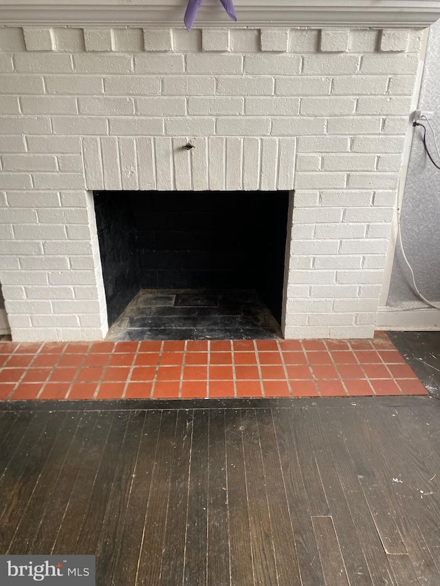 interior details with a brick fireplace and hardwood / wood-style floors