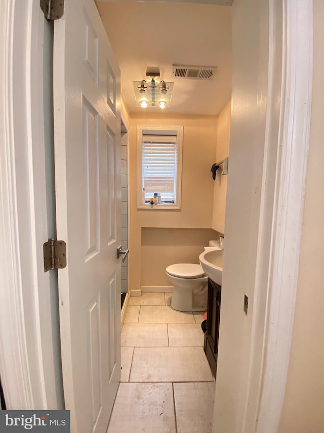 bathroom featuring vanity, tile patterned floors, and toilet