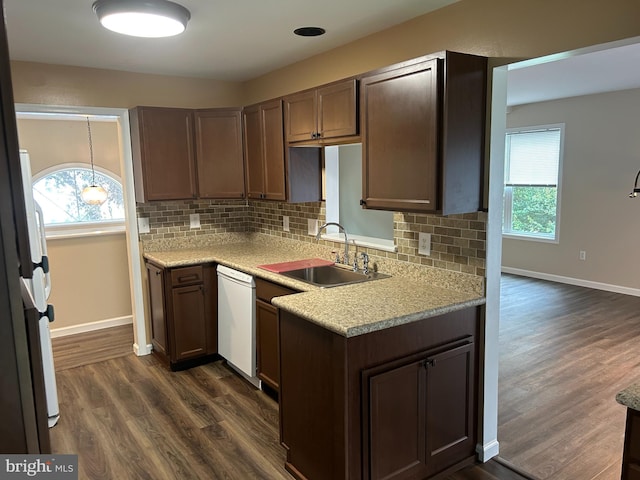 kitchen with white appliances, dark brown cabinetry, dark hardwood / wood-style flooring, sink, and backsplash