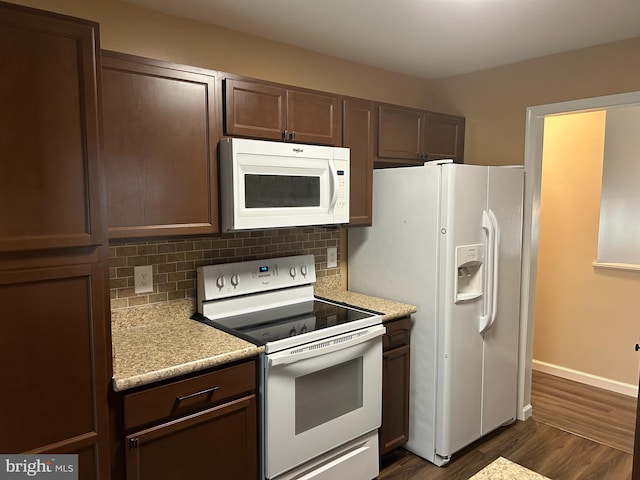 kitchen with dark wood-type flooring, white appliances, dark brown cabinets, and tasteful backsplash