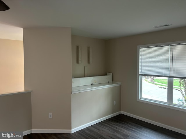 clothes washing area featuring dark wood-type flooring