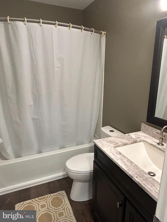 bathroom featuring toilet, hardwood / wood-style floors, and vanity