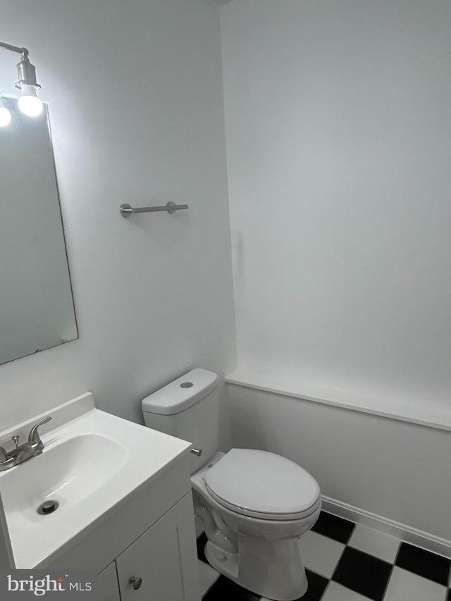 bathroom featuring toilet and vanity