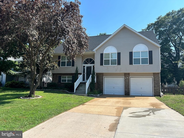 bi-level home with a front yard and a garage