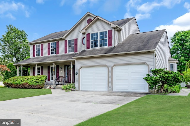 view of front of house with covered porch, a front yard, and a garage