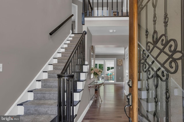 entryway featuring ornamental molding and hardwood / wood-style floors