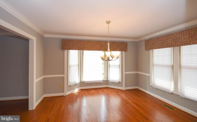 unfurnished dining area featuring wood-type flooring, a chandelier, and ornamental molding