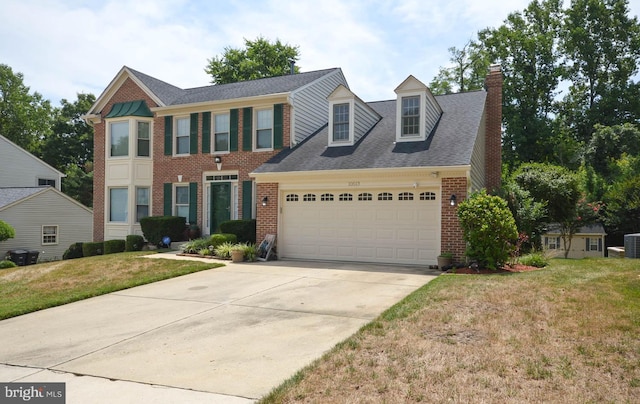 view of front of property with a garage and a front yard