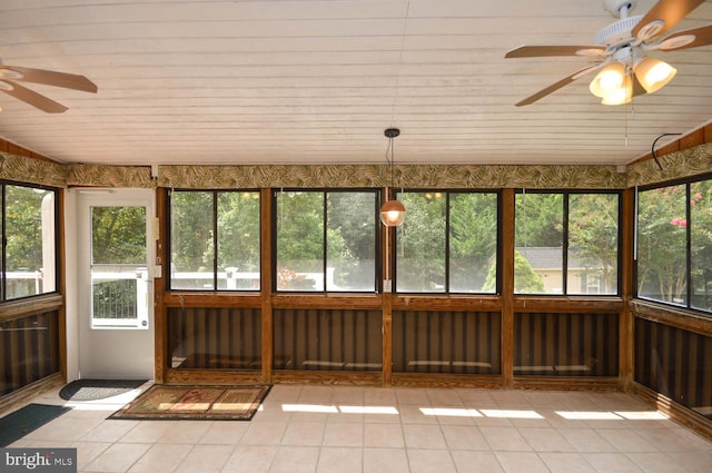 unfurnished sunroom with ceiling fan