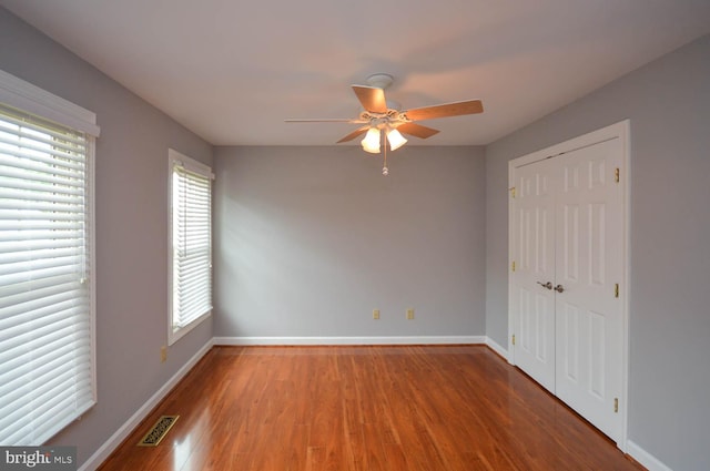 interior space with a healthy amount of sunlight, ceiling fan, and hardwood / wood-style floors