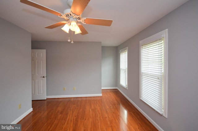 unfurnished room with ceiling fan and wood-type flooring