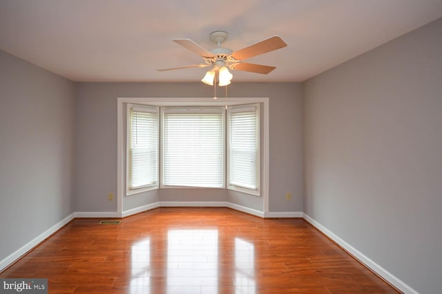 empty room featuring ceiling fan and hardwood / wood-style flooring