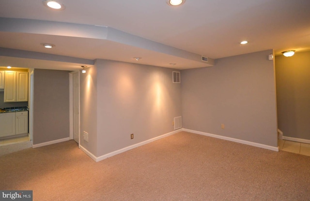 basement featuring light colored carpet