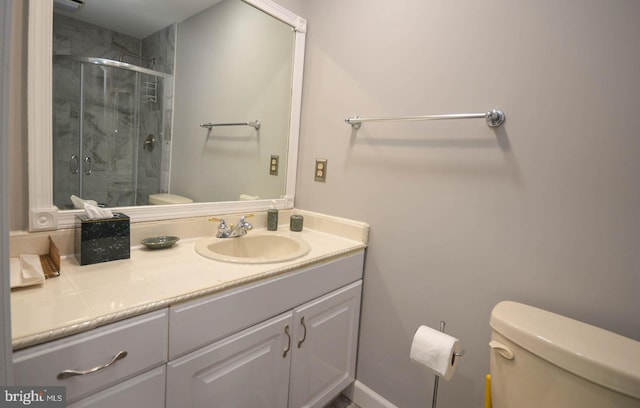 bathroom with vanity, an enclosed shower, and toilet