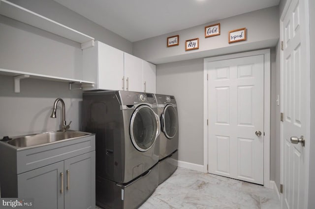 clothes washing area featuring cabinets, light tile patterned floors, separate washer and dryer, and sink