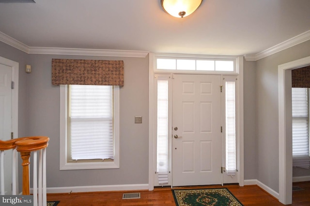 entrance foyer featuring crown molding and hardwood / wood-style flooring