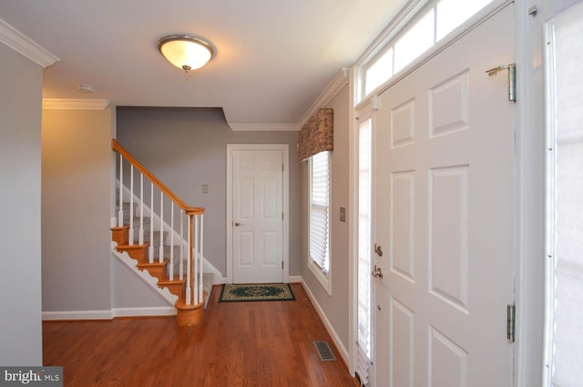 entryway featuring wood-type flooring and ornamental molding