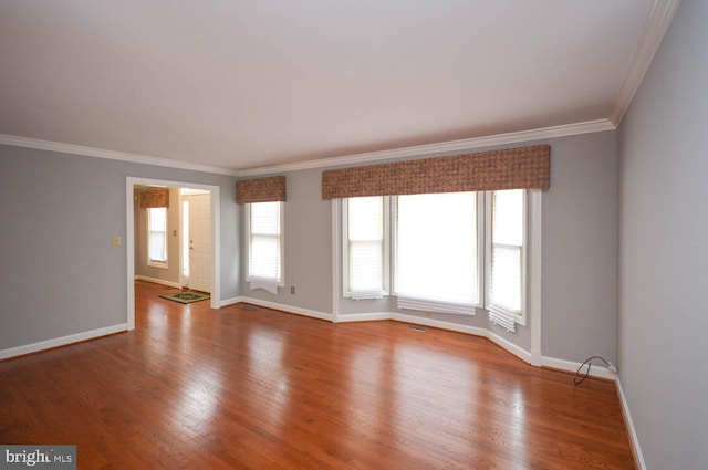 unfurnished room featuring crown molding and hardwood / wood-style floors