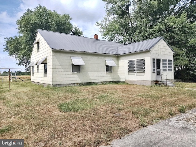 view of side of property with a lawn