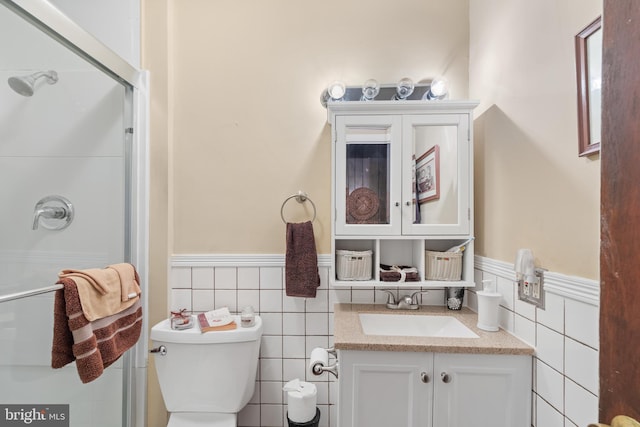 bathroom featuring vanity, a shower with door, and toilet