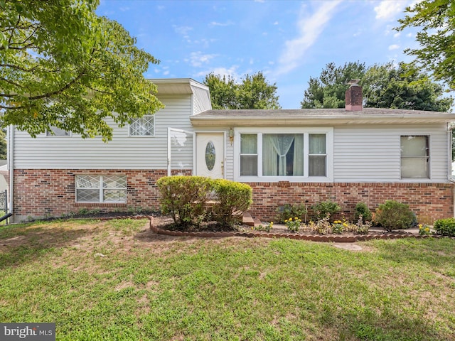 split level home featuring a front lawn