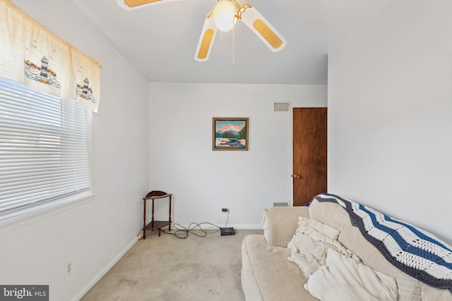 sitting room featuring light colored carpet and ceiling fan