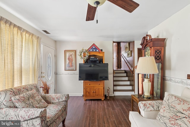 living room featuring dark hardwood / wood-style flooring and ceiling fan