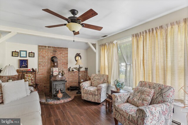 living room with a wood stove, ceiling fan, and baseboard heating