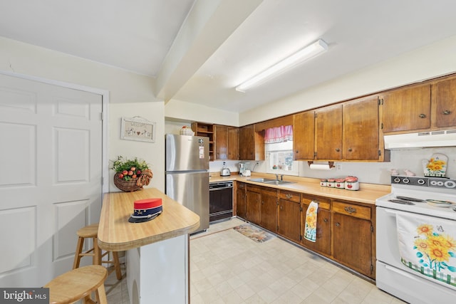 kitchen featuring stainless steel refrigerator, white range with electric stovetop, black dishwasher, sink, and a kitchen bar