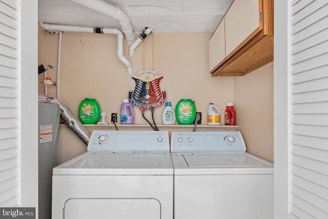 clothes washing area with cabinets, independent washer and dryer, and electric water heater