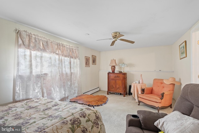 bedroom with baseboard heating, ceiling fan, and light colored carpet