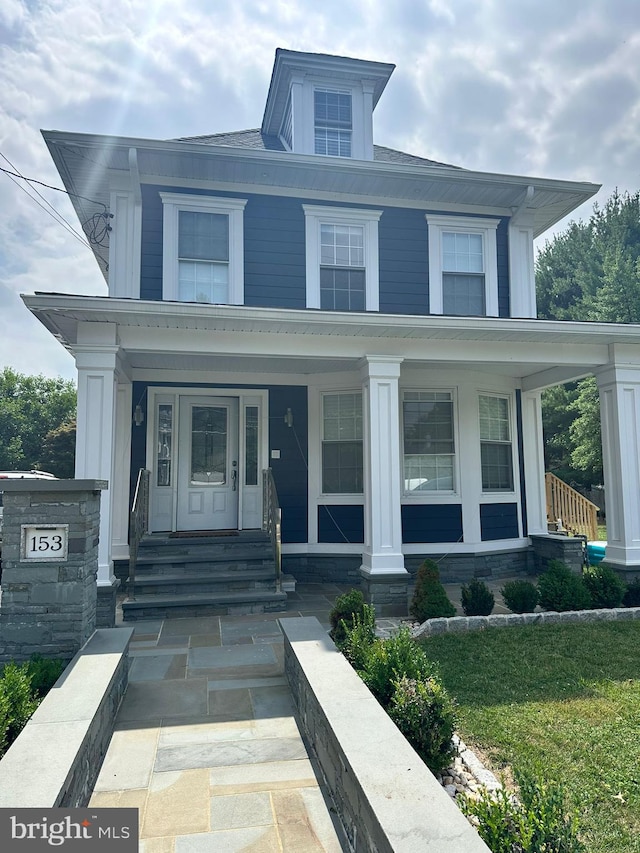 view of front of property with a front lawn and a porch