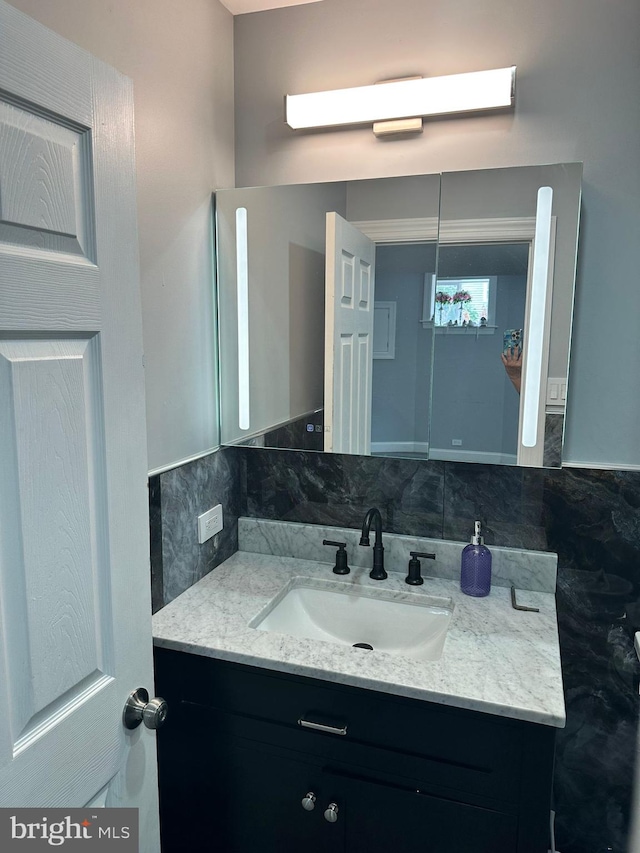 bathroom with vanity and backsplash